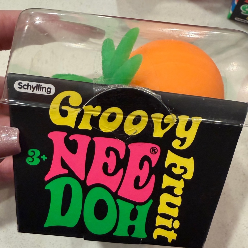 Schylling Groovy NeeDoh Orange Fruit Sensory Toy with Green Leaf